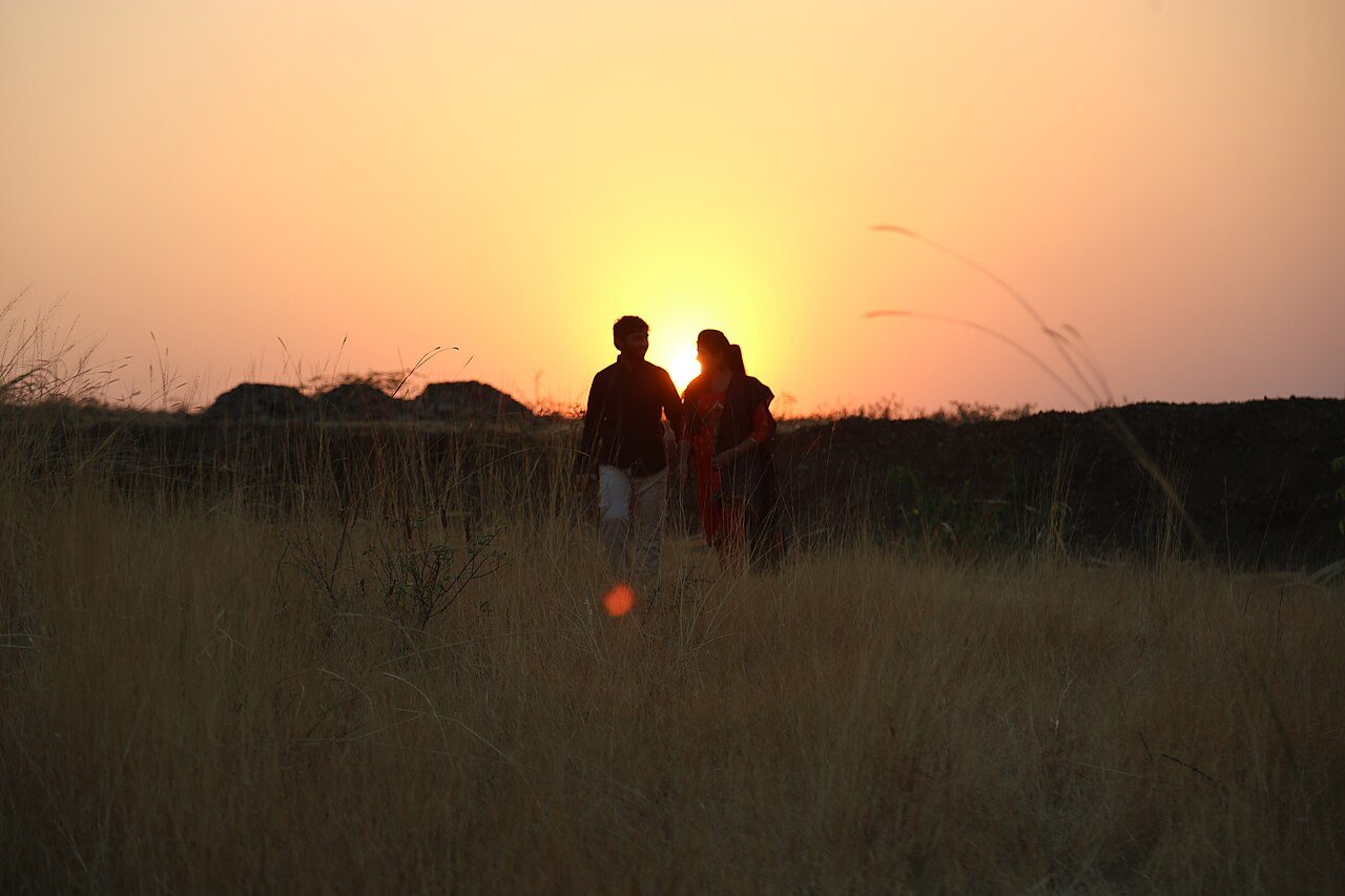A couple silhouetted against the sunset